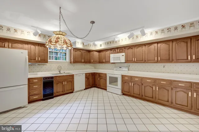 a kitchen with stainless steel appliances a sink stove and cabinets