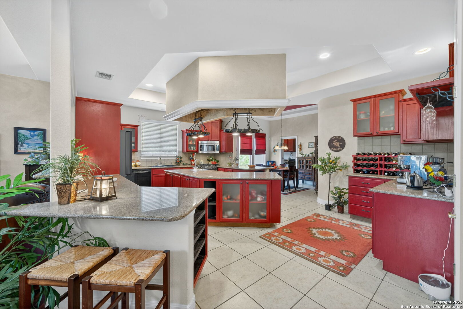 29019 Tivoli Way Fair Oaks Ranch, TX 78015 - Photo 11 of 33 a kitchen with stainless steel appliances kitchen island granite countertop a table chairs in it and wooden floors