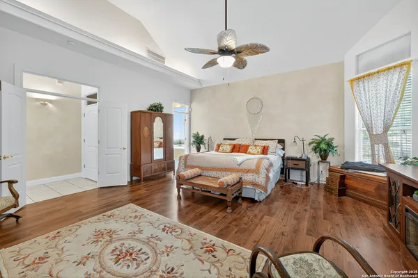 a bedroom with a bed furniture and wooden floor