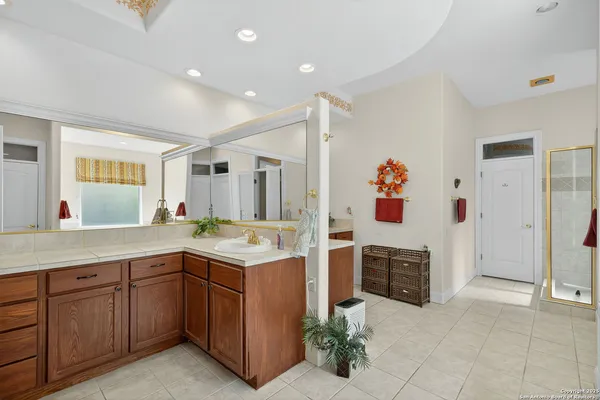 a spacious kitchen with stainless steel appliances granite countertop a stove and a sink