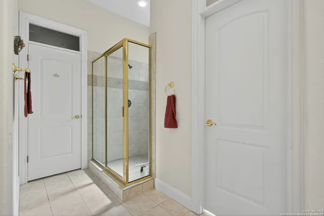 a bathroom with a shower and mirror