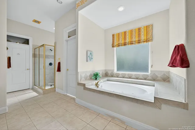 a bathroom with a tub shower and a sink