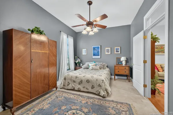 a bedroom with a bed dresser and a window