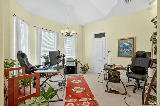 a living room with furniture a rug and a chandelier