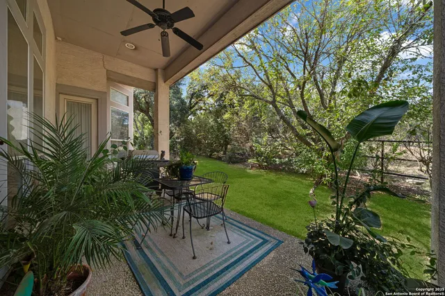 a view of a chairs and table in patio with a garden