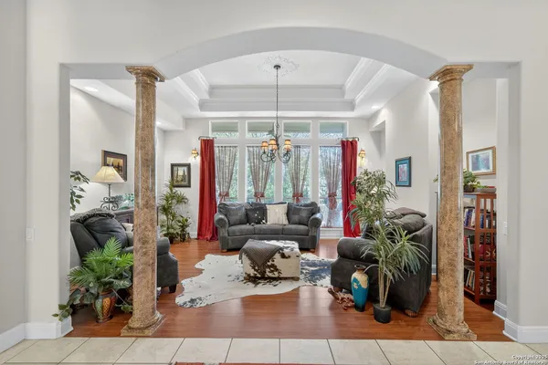 a living room with furniture and a chandelier