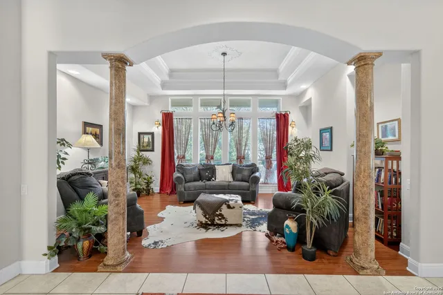 a living room with furniture and a chandelier