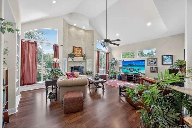a living room with furniture a fireplace and a flat screen tv