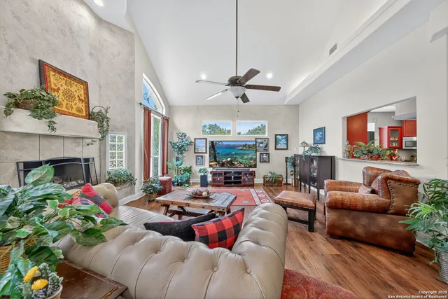 a living room with furniture fireplace and a large window