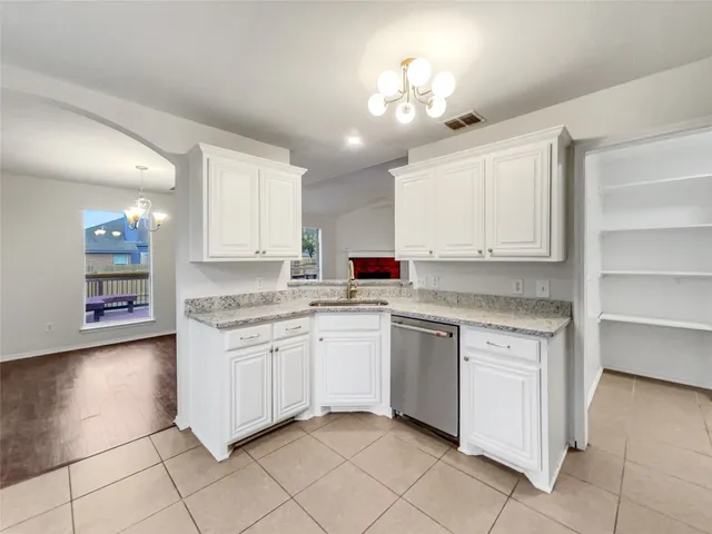 a kitchen with cabinets and appliances