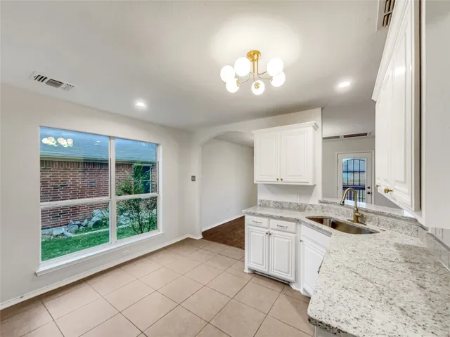 a kitchen with a stove a sink and a refrigerator