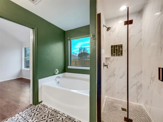 a bathroom with a bathtub and a shower