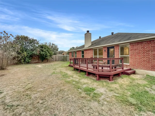 a view of a house with yard and sitting area