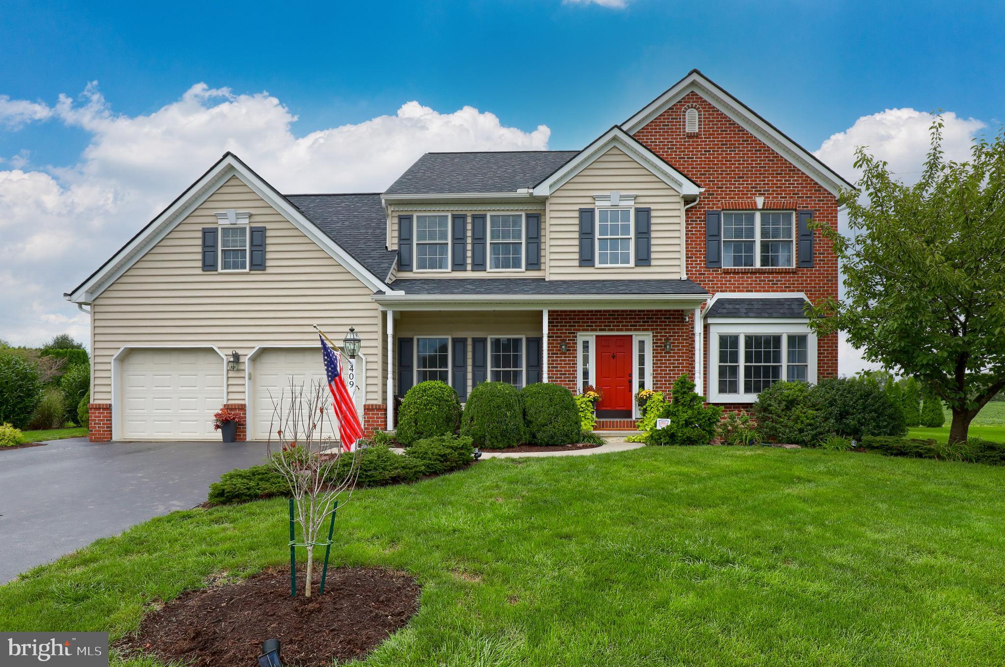 409 Wagonwheel Road Lititz, PA 17543 - Photo 1 of 40 a front view of a house with garden