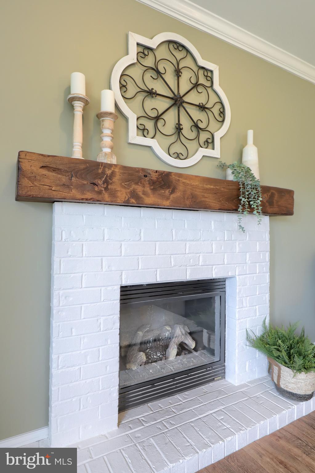 409 Wagonwheel Road Lititz, PA 17543 - Photo 14 of 40 a fireplace with a clock on top of it