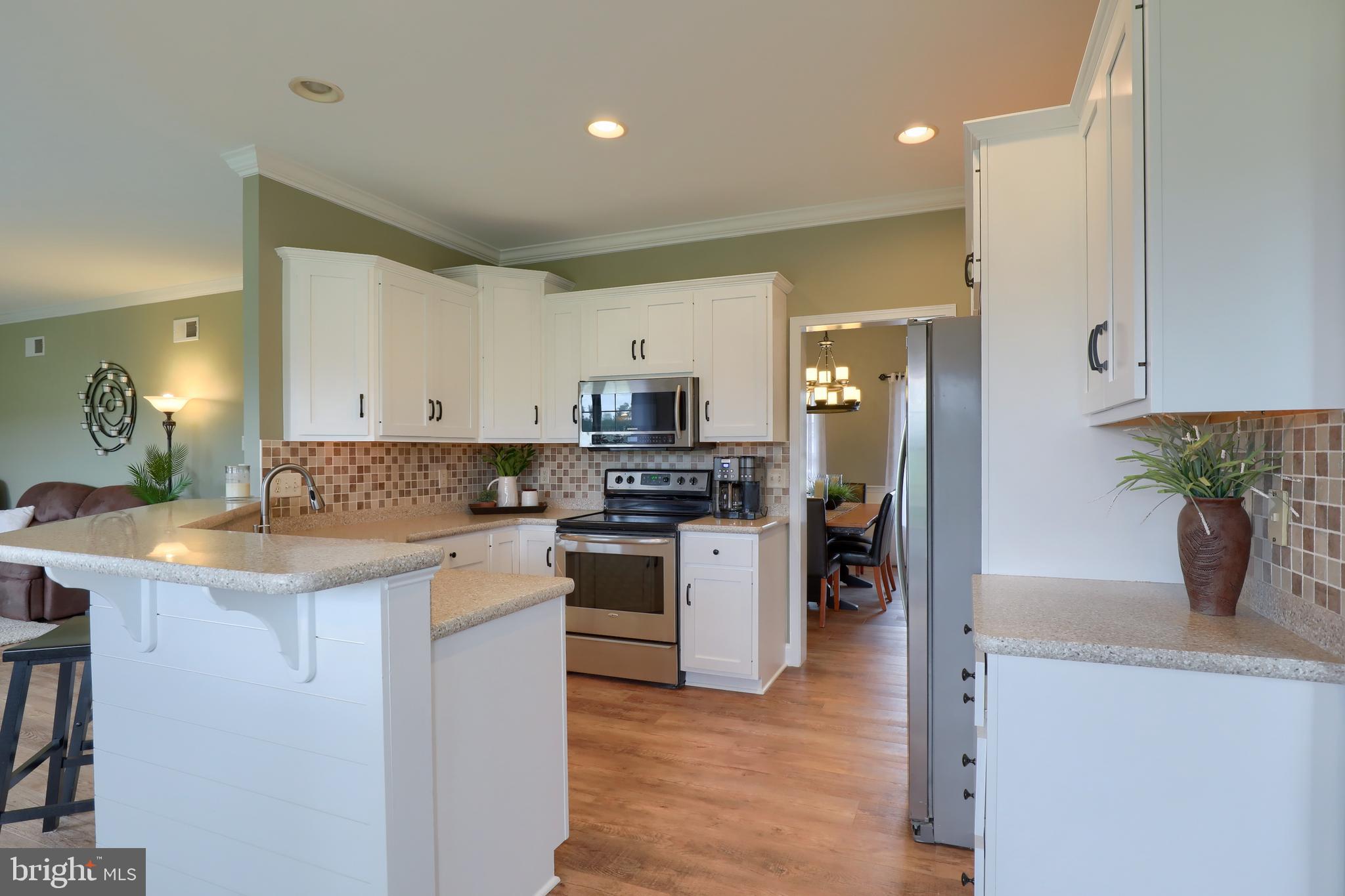 409 Wagonwheel Road Lititz, PA 17543 - Photo 15 of 40 a kitchen with a refrigerator a stove top oven a sink and cabinets