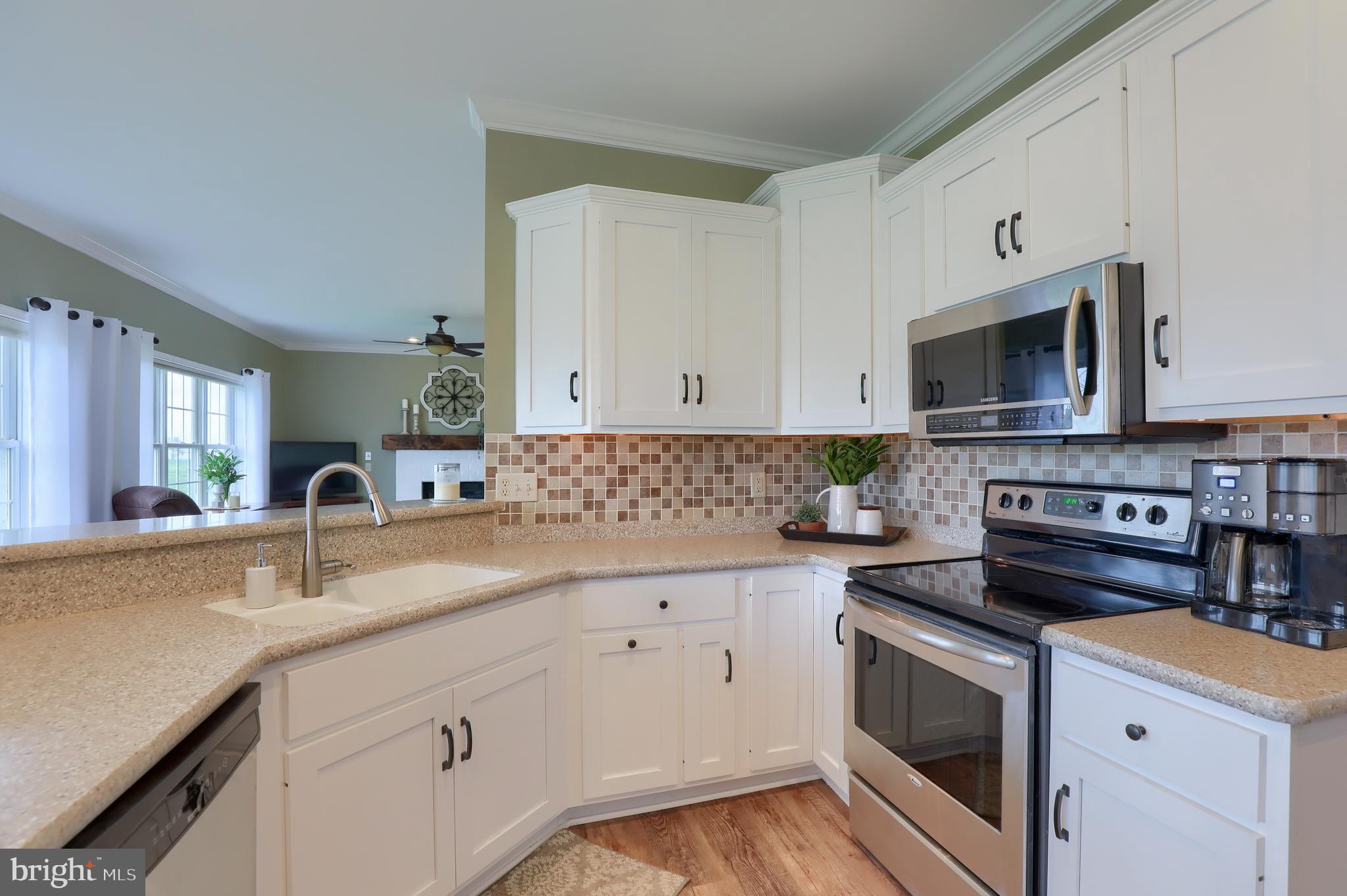 409 Wagonwheel Road Lititz, PA 17543 - Photo 16 of 40 a kitchen with granite countertop a stove a sink and a microwave