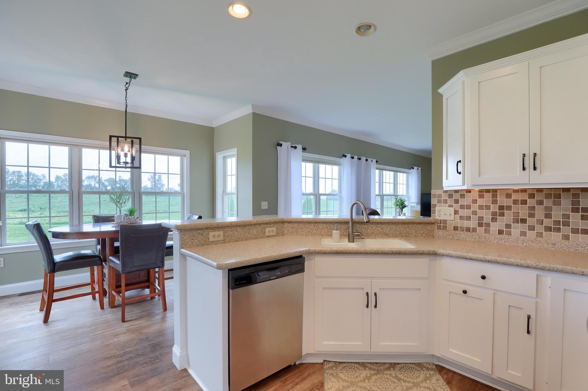 409 Wagonwheel Road Lititz, PA 17543 - Photo 18 of 40 a kitchen with a stove a sink a dining table and chairs