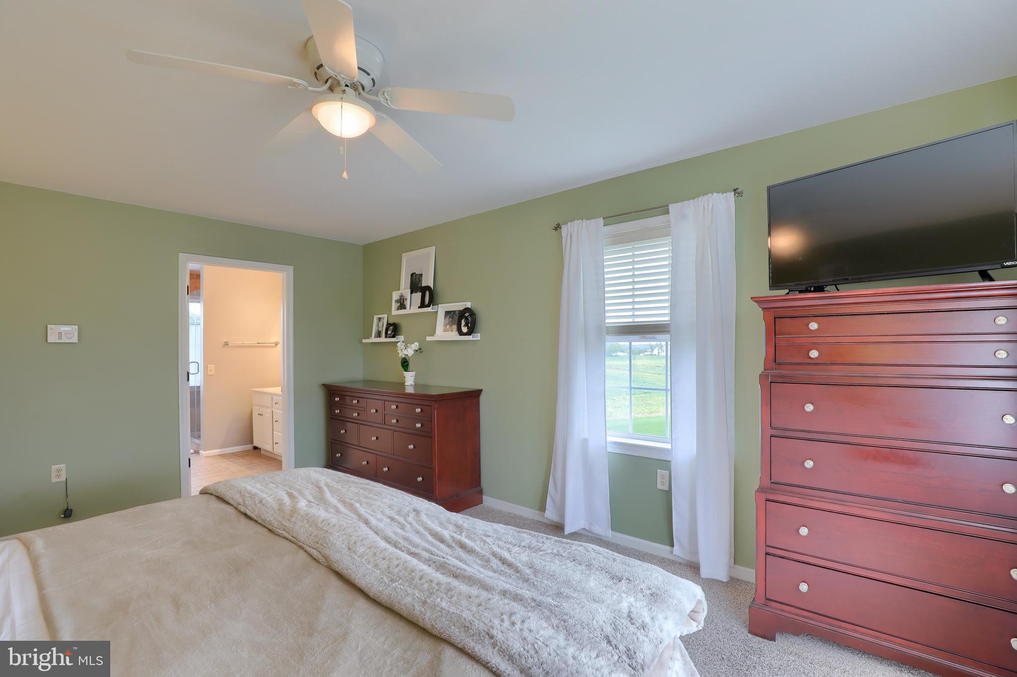 409 Wagonwheel Road Lititz, PA 17543 - Photo 30 of 40 a bedroom with a bed and a flat screen tv