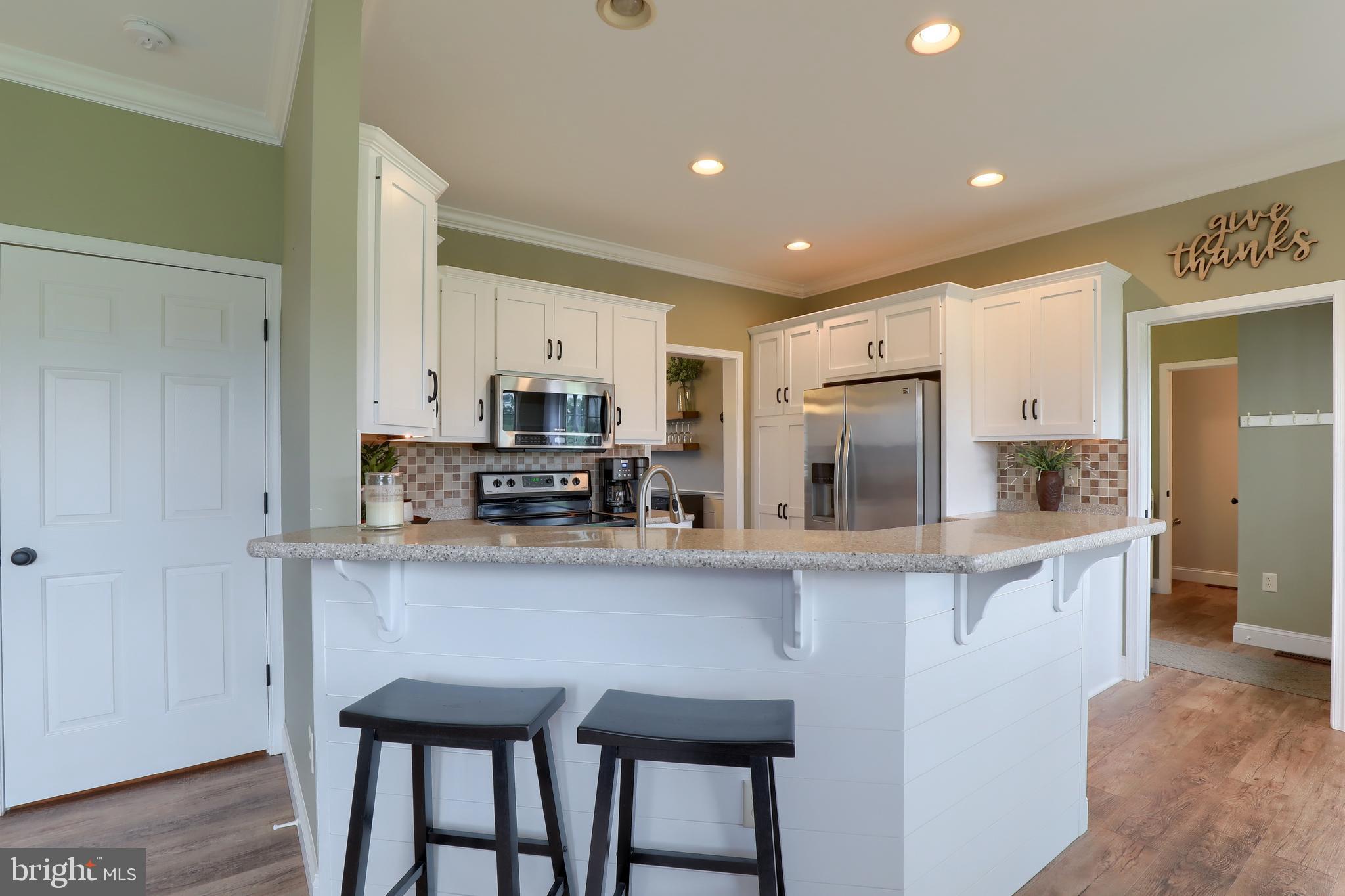409 Wagonwheel Road Lititz, PA 17543 - Photo 4 of 40 a kitchen with stainless steel appliances granite countertop a stove top oven a sink and cabinets