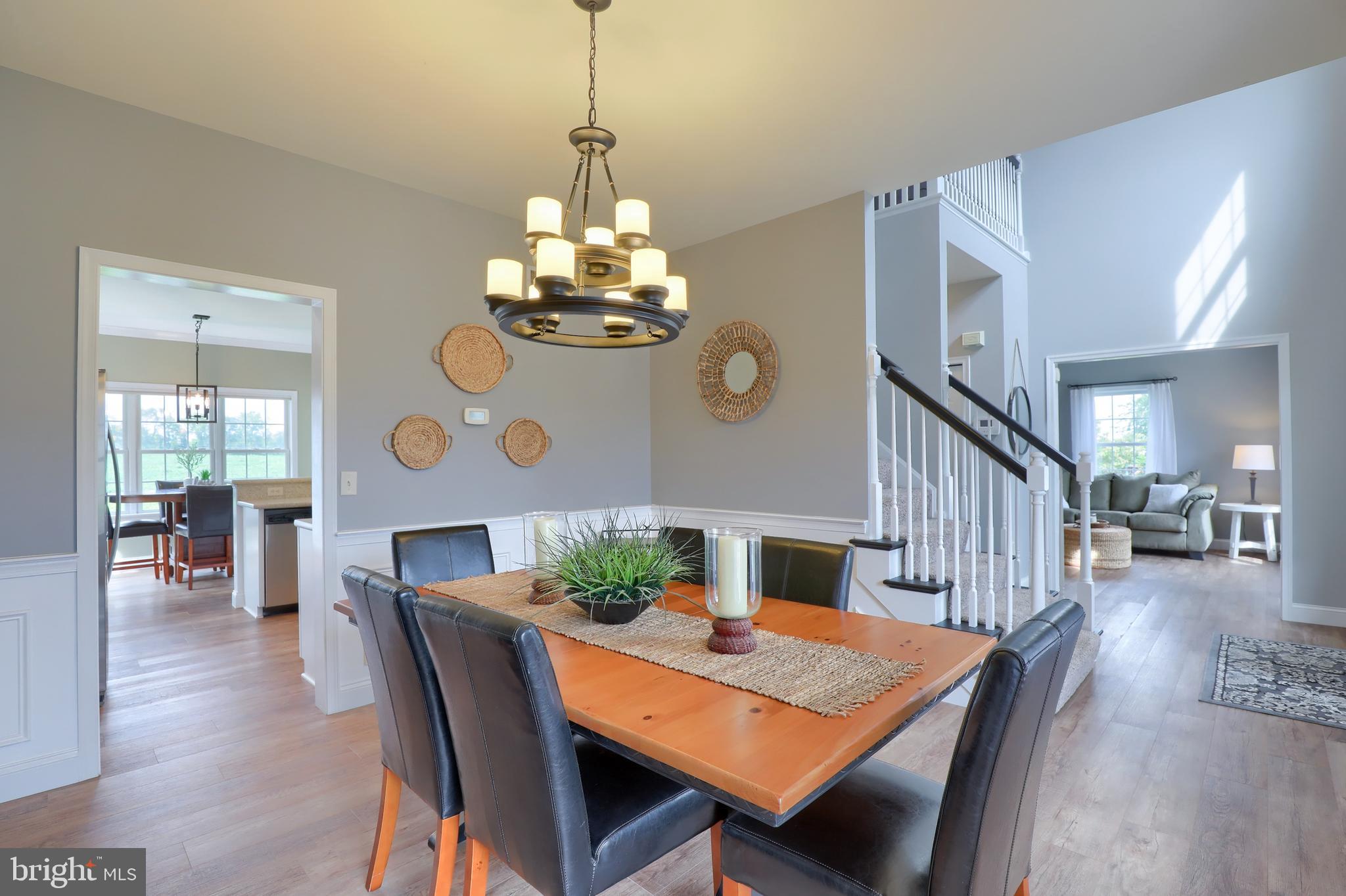 409 Wagonwheel Road Lititz, PA 17543 - Photo 5 of 40 a view of a dining room with furniture a chandelier and wooden floor