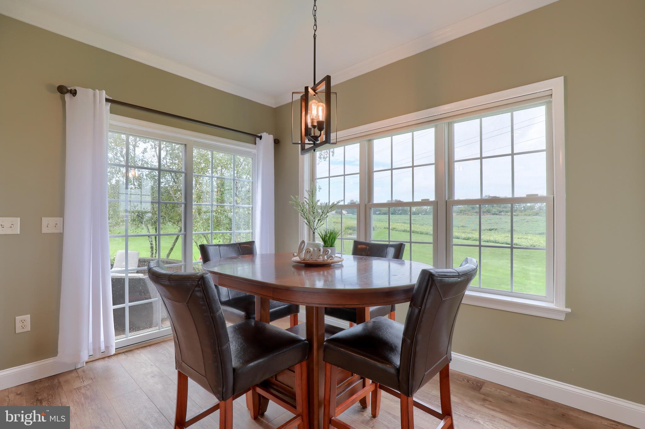 409 Wagonwheel Road Lititz, PA 17543 - Photo 7 of 40 a view of a dining room with furniture large windows and wooden floor