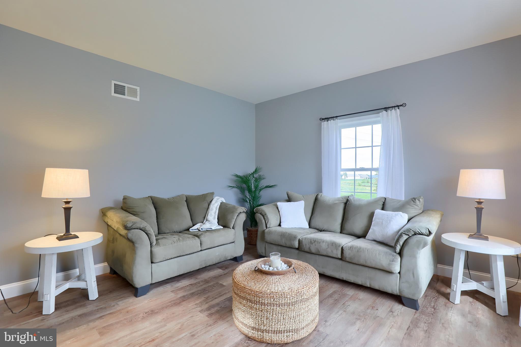 409 Wagonwheel Road Lititz, PA 17543 - Photo 10 of 40 a living room with furniture and a lamp