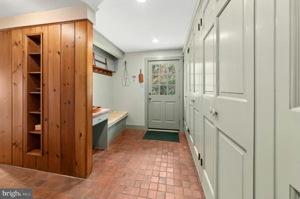 a bedroom with a bed wooden floor and window