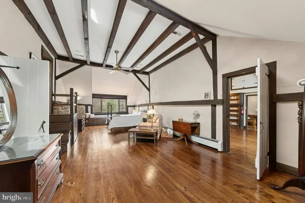 a view of a livingroom with furniture and hardwood floor