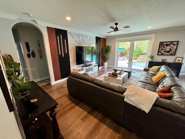 a living room with furniture fireplace and a large window