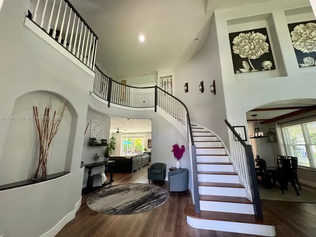 a view of entryway and hall with wooden floor