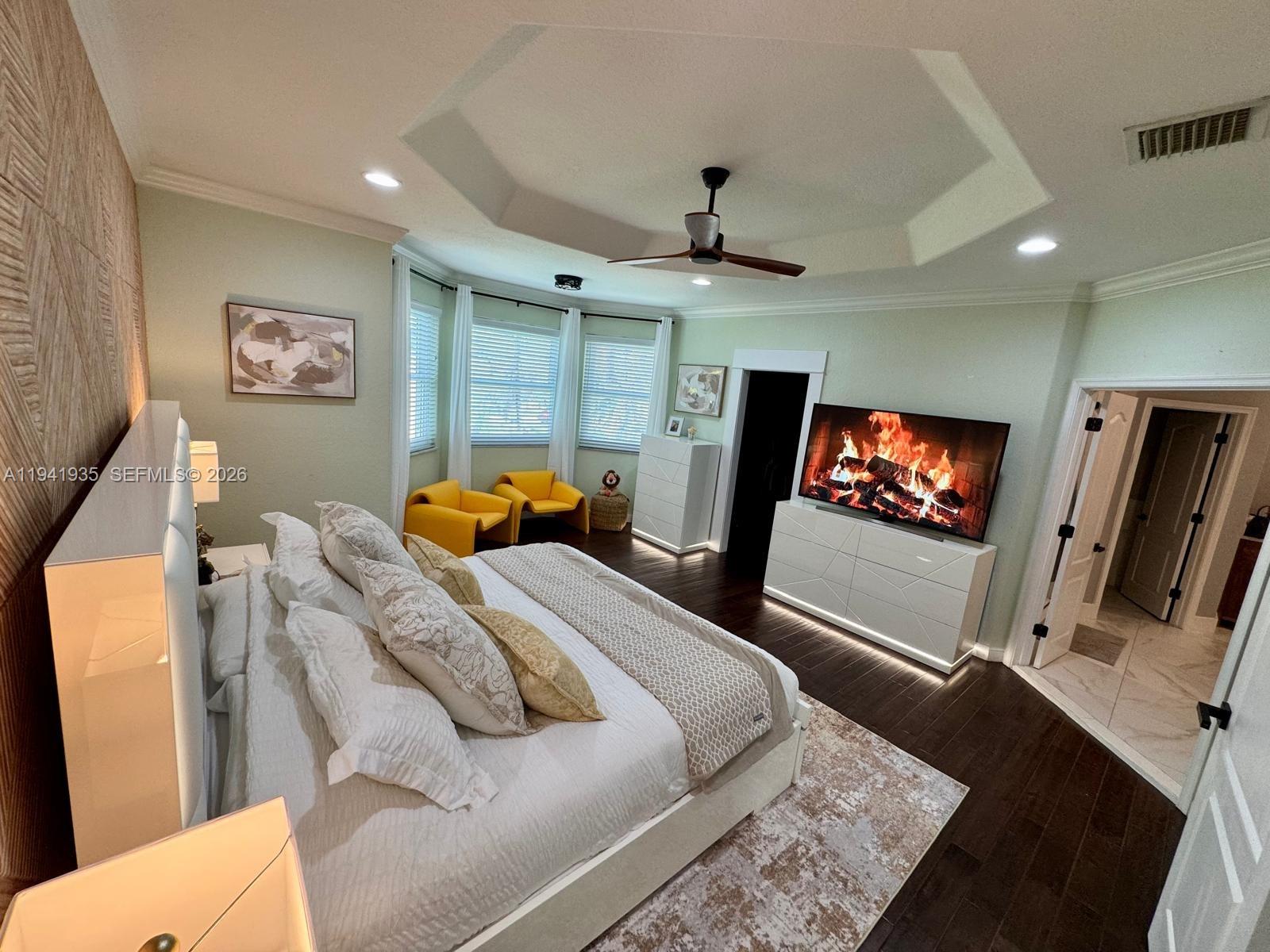 12917 Southwest 23rd Street Miramar, FL 33027 - Photo 12 of 47 a bedroom with a bed and a flat screen tv