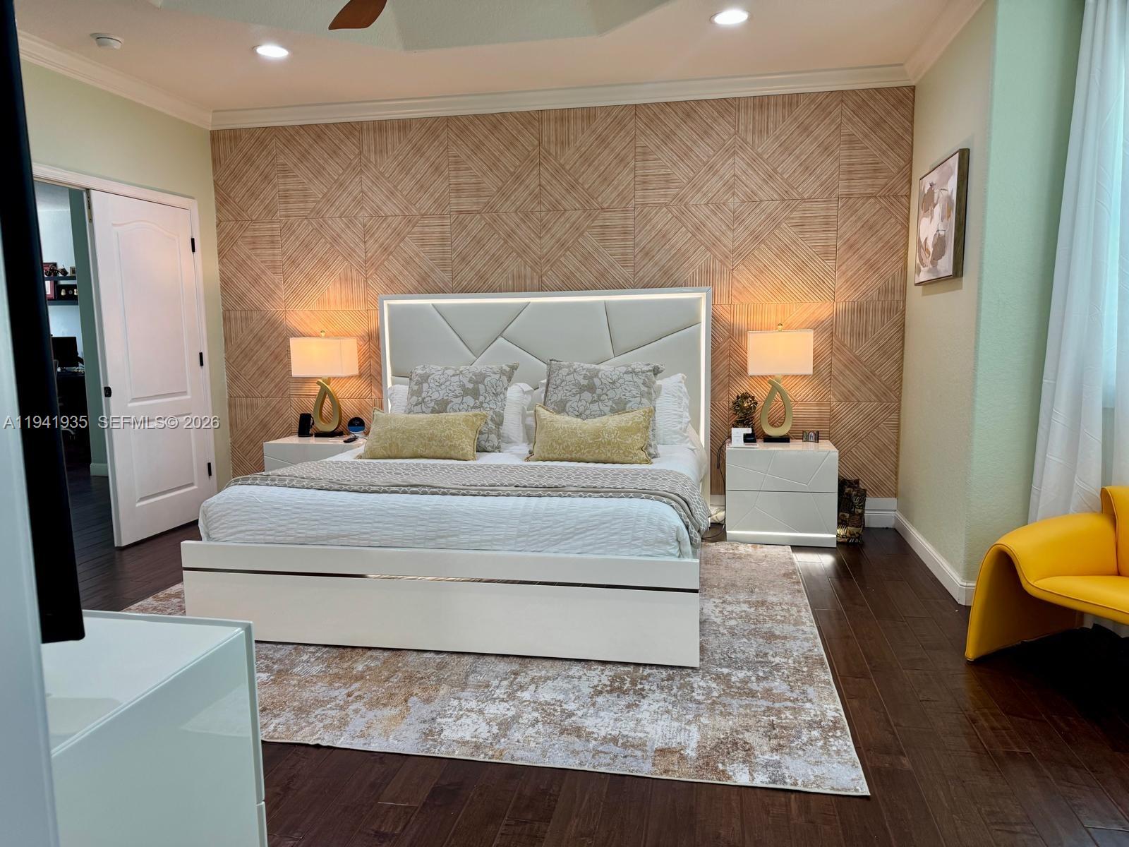 12917 Southwest 23rd Street Miramar, FL 33027 - Photo 16 of 47 a spacious bedroom with a bed and a couch