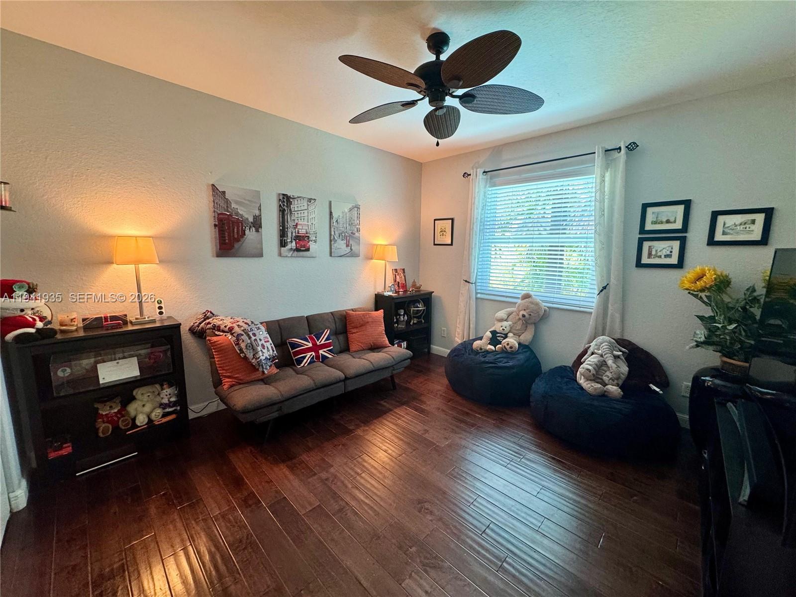 12917 Southwest 23rd Street Miramar, FL 33027 - Photo 21 of 47 a living room with furniture and a flat screen tv