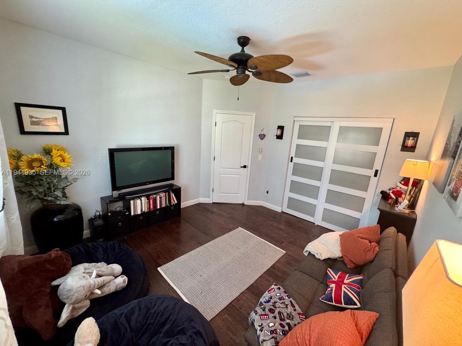 12917 Southwest 23rd Street Miramar, FL 33027 - Photo 22 of 47 a living room with furniture and a flat screen tv