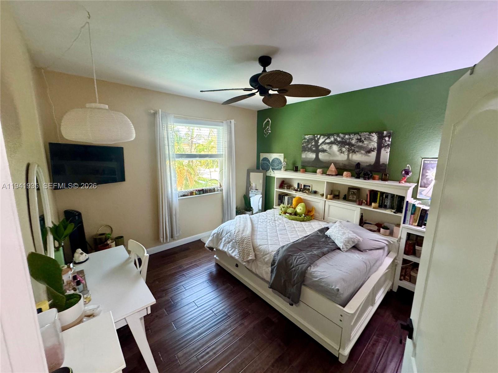 12917 Southwest 23rd Street Miramar, FL 33027 - Photo 23 of 47 a bedroom with a bed wooden floor and window