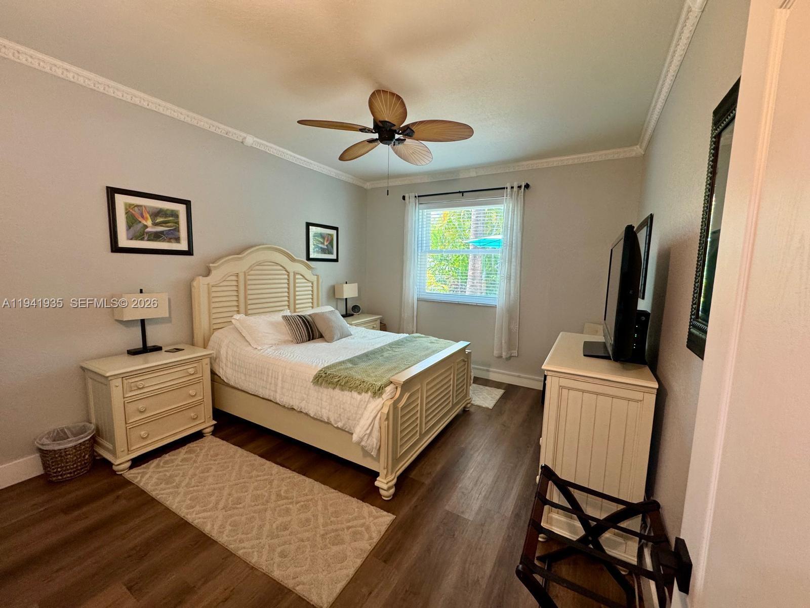12917 Southwest 23rd Street Miramar, FL 33027 - Photo 29 of 47 a bedroom with a bed and a flat screen tv