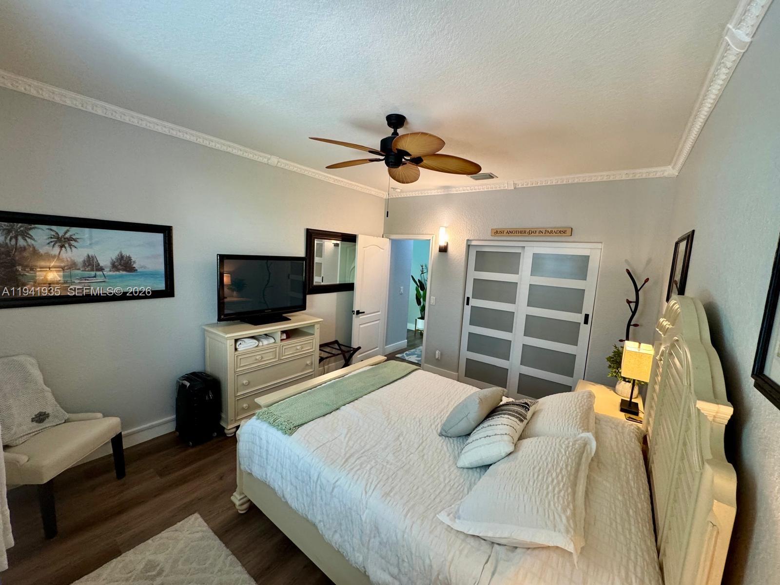 12917 Southwest 23rd Street Miramar, FL 33027 - Photo 30 of 47 a bedroom with a bed and a flat screen tv