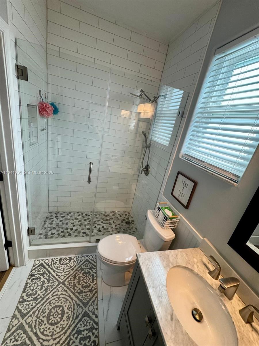 12917 Southwest 23rd Street Miramar, FL 33027 - Photo 33 of 47 a bathroom with a sink a toilet and shower