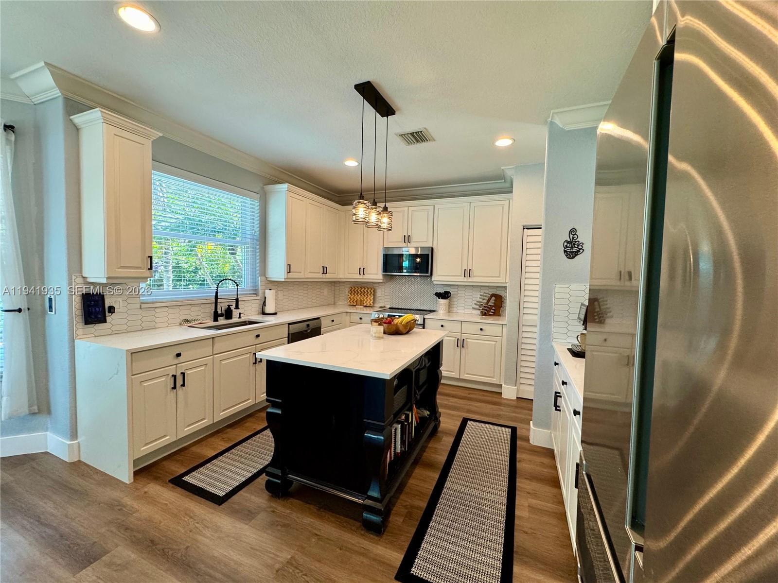 12917 Southwest 23rd Street Miramar, FL 33027 - Photo 6 of 47 a kitchen with a sink stainless steel appliances and window