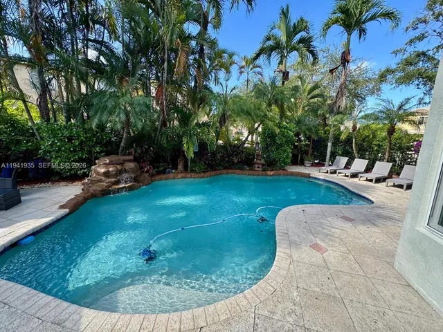 a view of a backyard with swimming pool