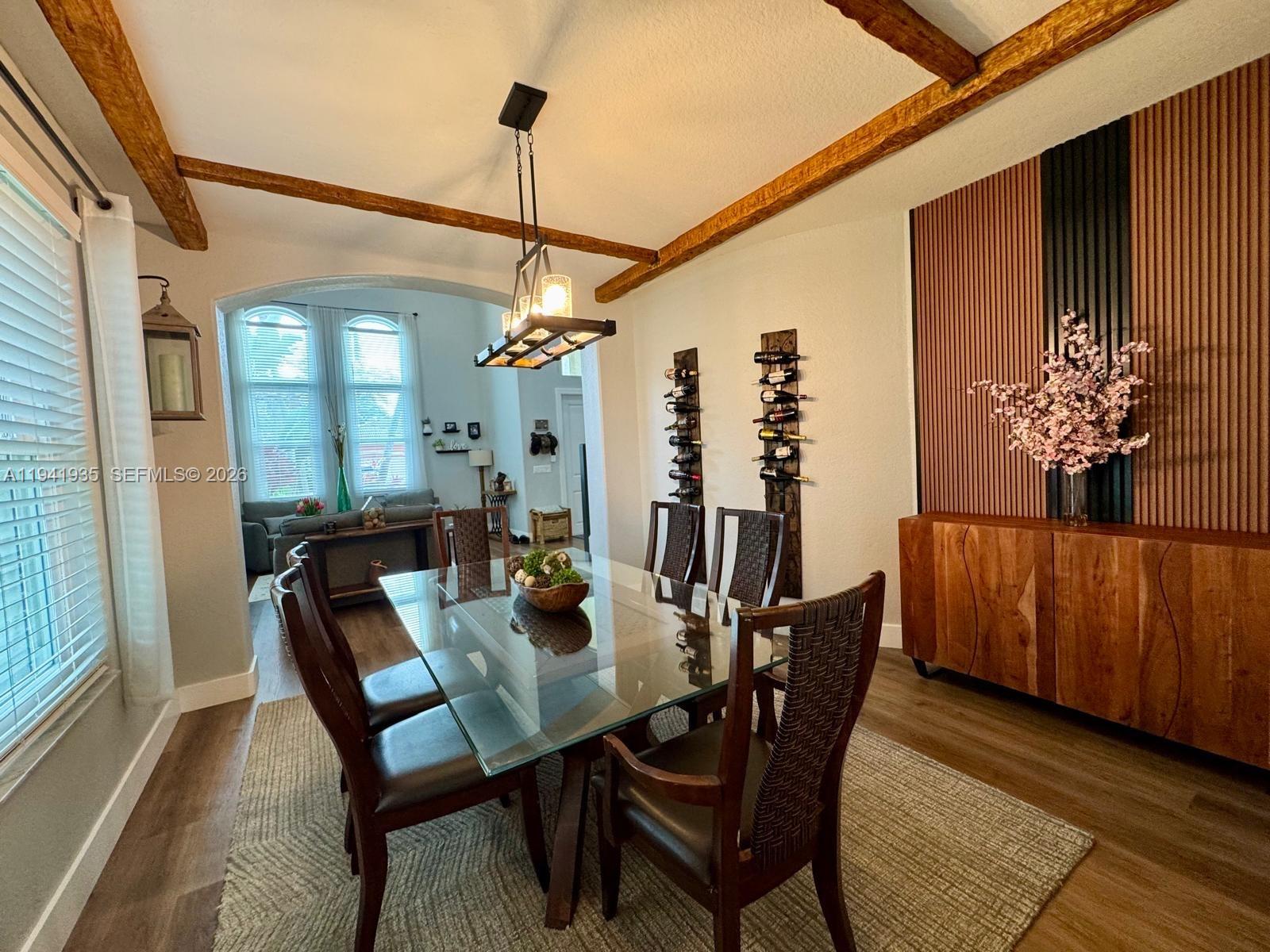12917 Southwest 23rd Street Miramar, FL 33027 - Photo 10 of 47 a view of a dining room with furniture window and wooden floor
