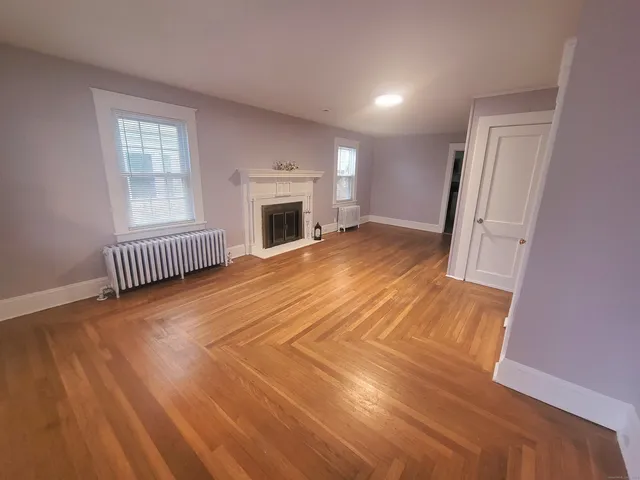 wooden floor in a hall with a window