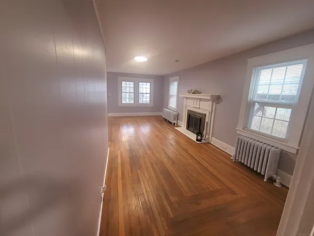 a kitchen with granite countertop stainless steel appliances a refrigerator a sink and white cabinets