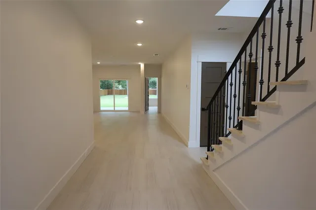an entryway and stairs with wooden floor