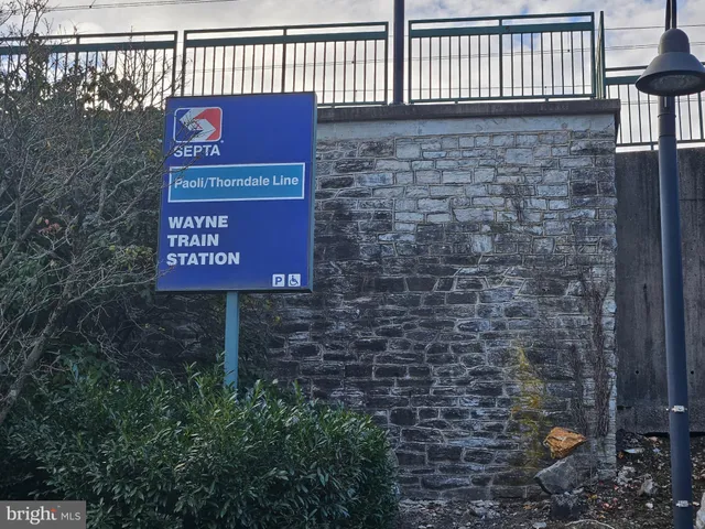 a sign board with parking in front of it