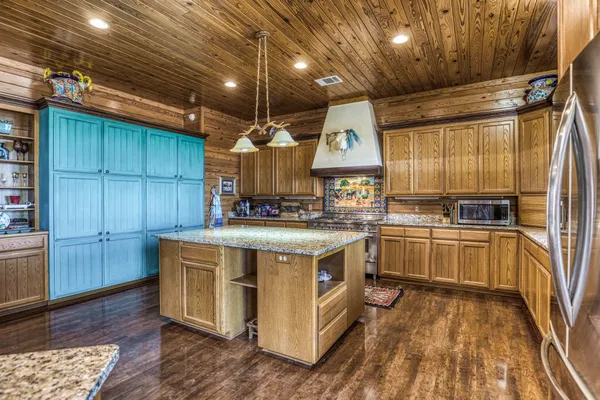 a kitchen with a stove and a refrigerator