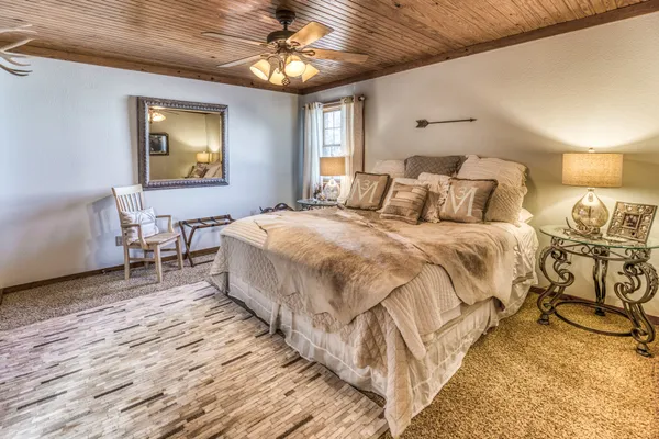 a bedroom with a bed and a chandelier