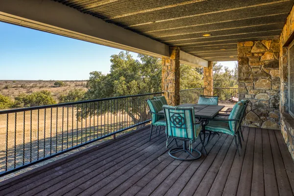 a view of a chairs and table on the balcony