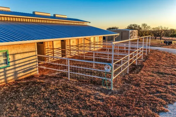 a view of a yard with wooden fence